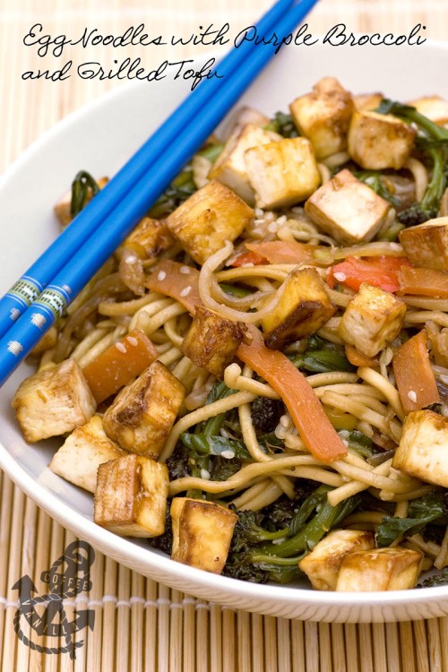 egg noodles purple broccoli grilled tofu in a bowl with chopsticks