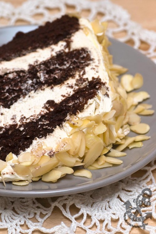 triple layer chocolate cake with coffee whipped cream and almonds