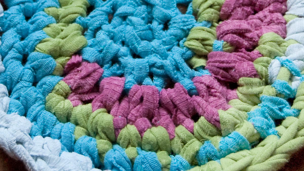 Close-up photo crocheting t-shirt yarn into a rug - Knit & Crochet