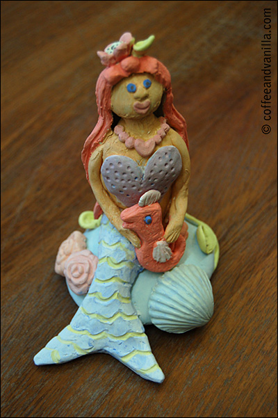 clay mermaid with a seahorse pet statue