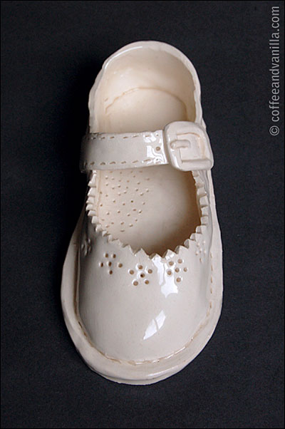 glazed white clay baby shoe