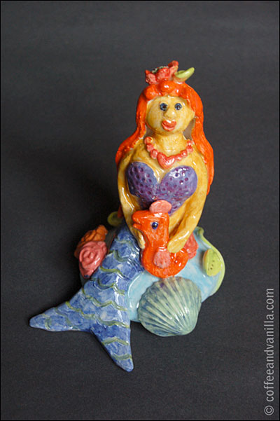seating mermaid with a seahorse
