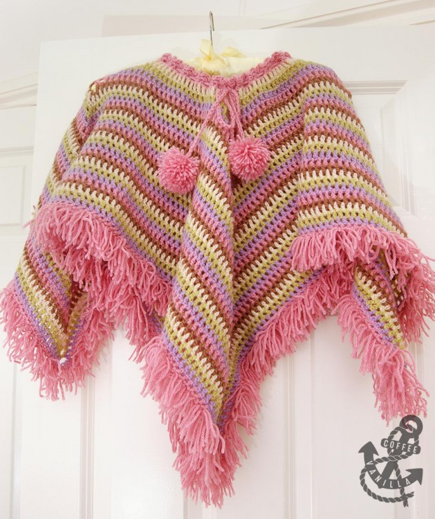 girls poncho cape with pom poms and tear drop corners 